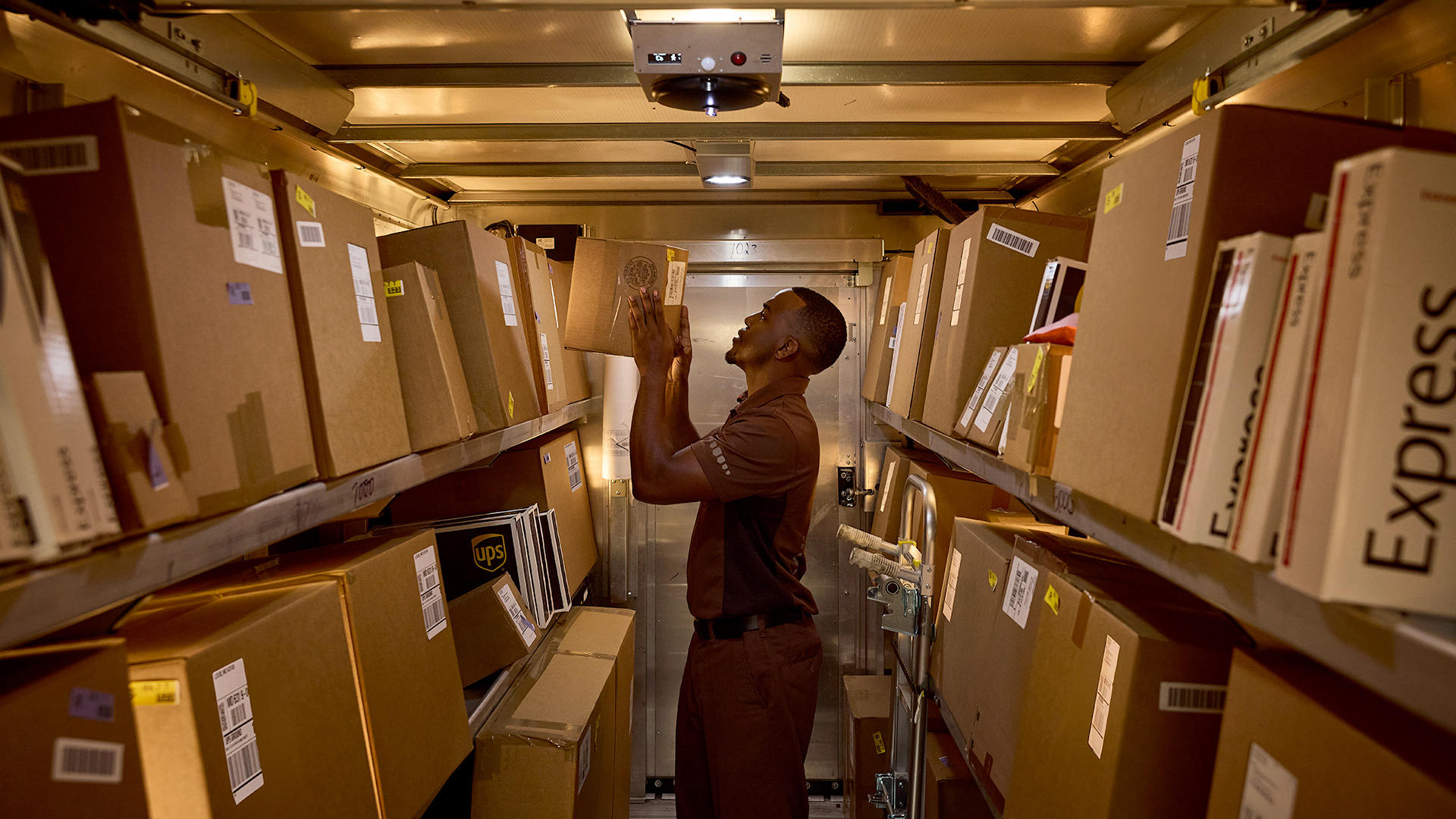 UPSer Organizing Packages Inside Delivery Truck
