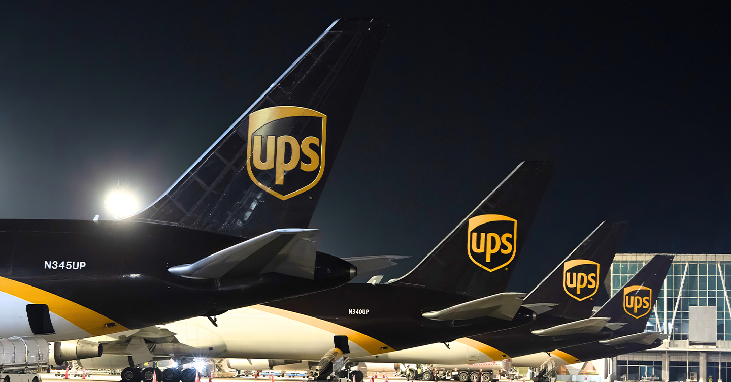 UPS cargo airplanes lined up at night