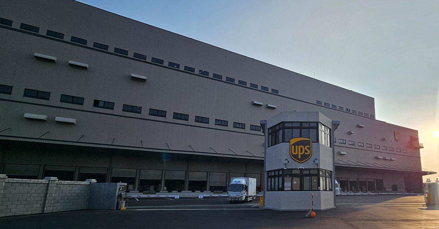 Logistics building with UPS logo at sunrise