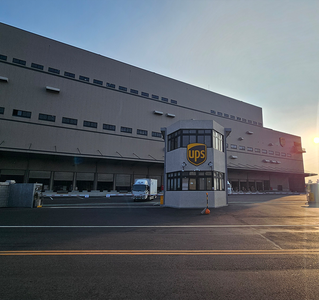 Logistics building with UPS logo at sunrise