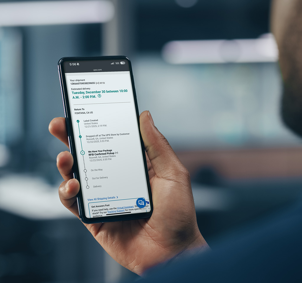 荷物追跡情報のある携帯電話を持っている男性