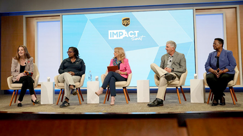 A panel of speakers on stage