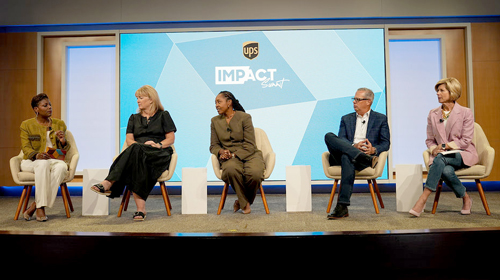 A panel of speakers on stage