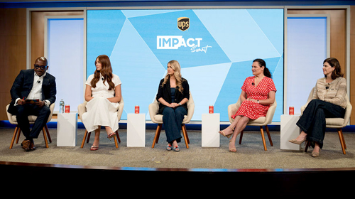 A panel of speakers on stage