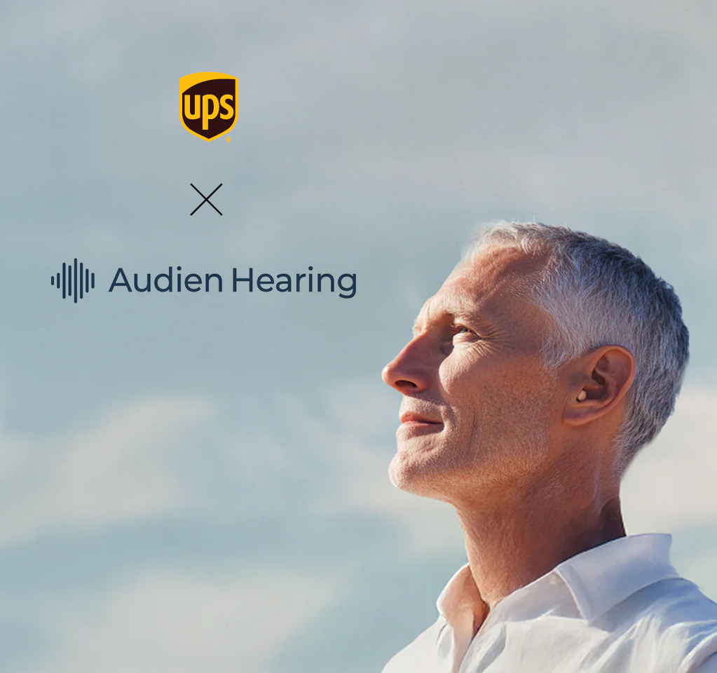 Man looking content as he stares to the clouds with hearing aid
