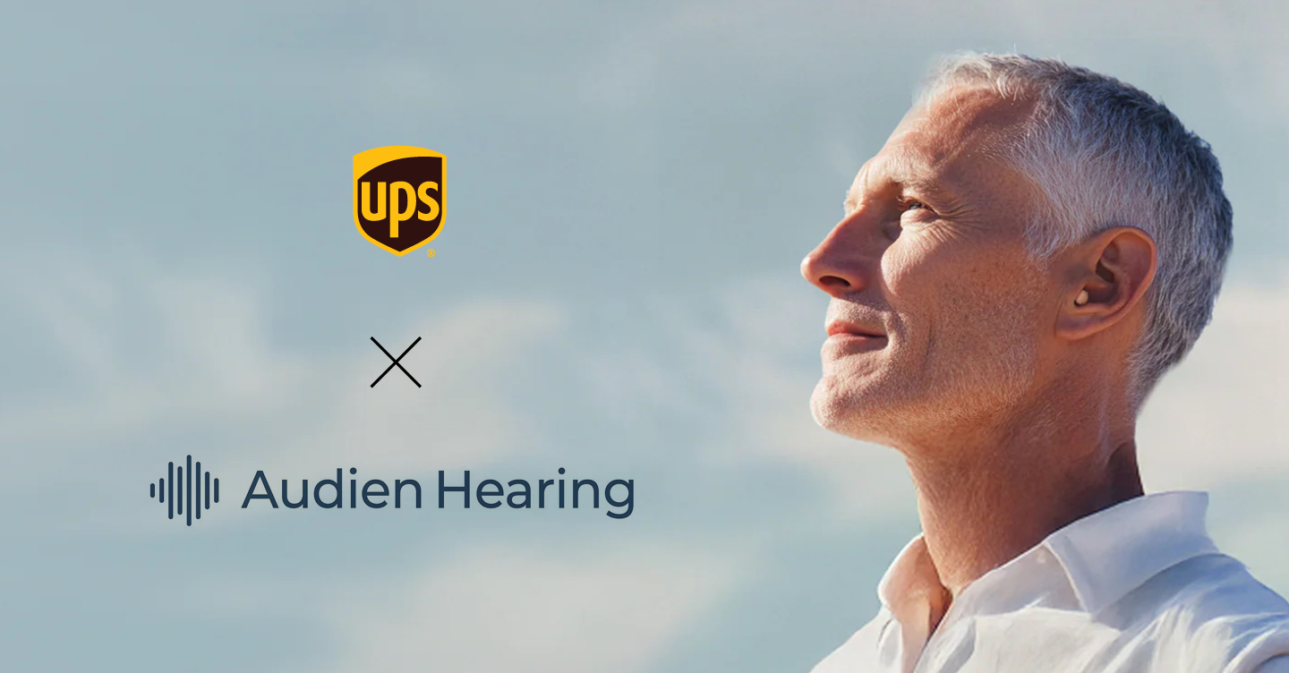 Man looking content as he stares to the clouds with hearing aid