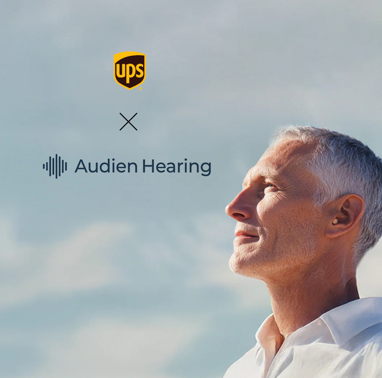Man looking content as he stares to the clouds with hearing aid
