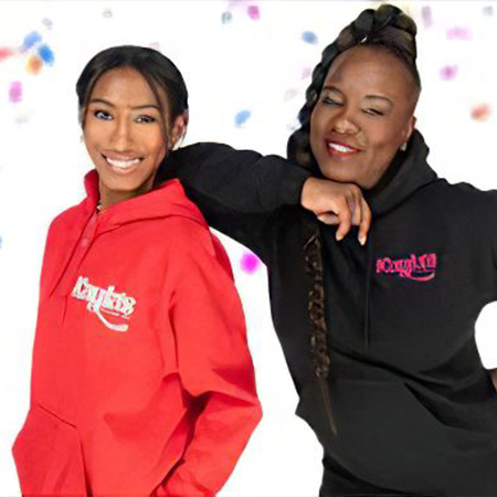 A portrait of of mother-daughter duo Theresa and Kayla smiling and leaning upon one another