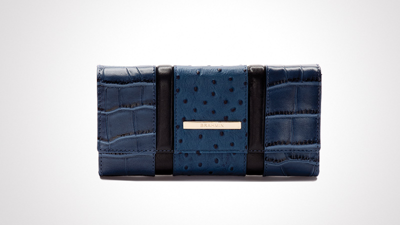 A sophisticated clutch wallet featuring a combination of crocodile-textured and ostrich-patterned blue leather. The wallet is accented with black leather strips and a metallic plate with visible text. The design is sleek and modern, ideal for formal or casual settings.