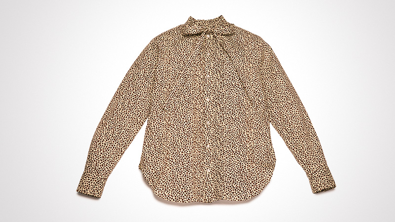 A stylish leopard print blouse with long sleeves, displayed flat against a white background. The design features a high neckline with subtle pleating details. The neutral tones of the print create a chic and versatile look.