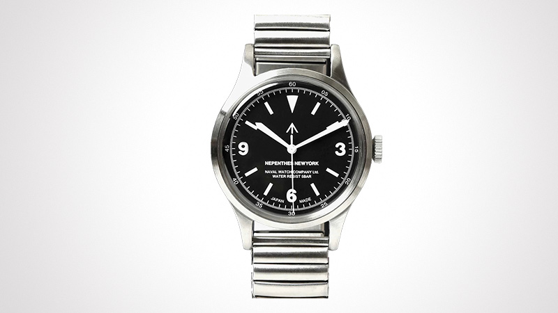 A sleek wristwatch featuring a stainless steel strap and a bold black dial. The watch face displays clear numeric markers at 3, 6, and 9 positions, along with a distinctive arrow symbol at the 12 o'clock position. The design is minimalistic and timeless, suitable for everyday wear.