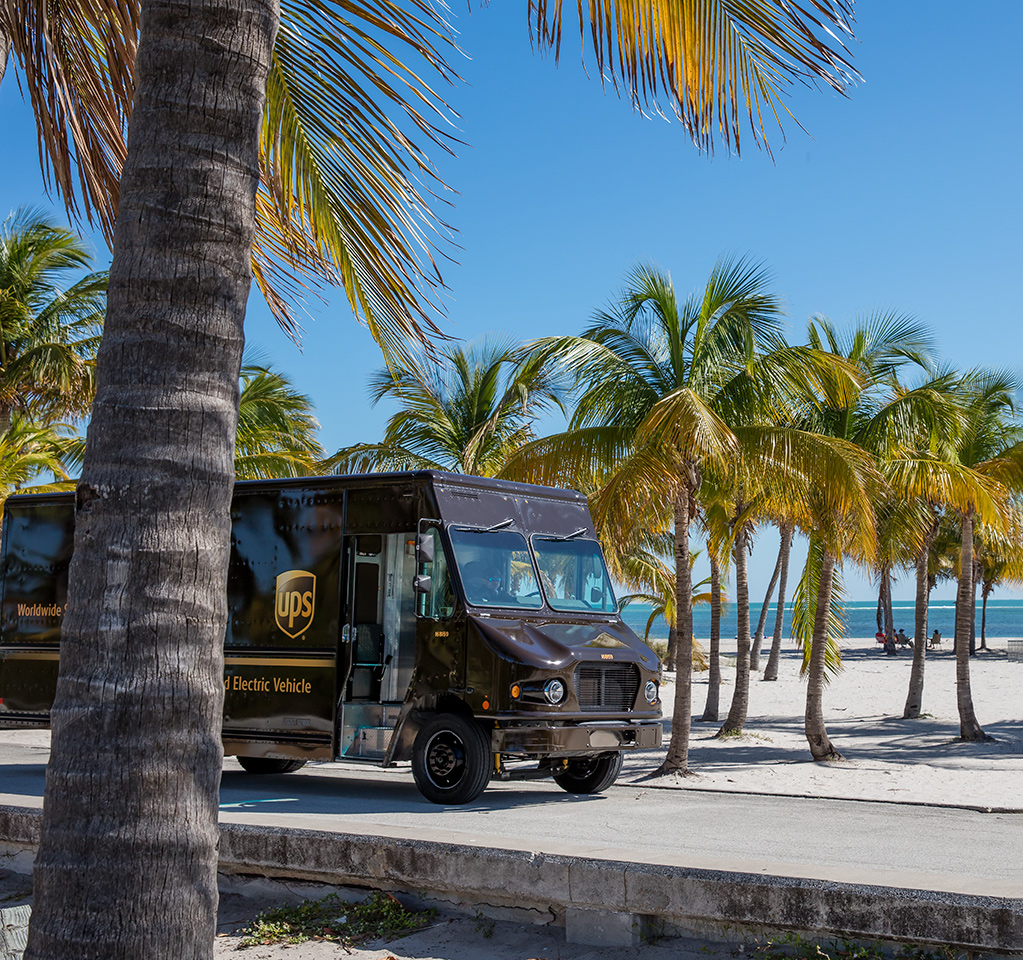 UPS electric vehicle on tropical beach road