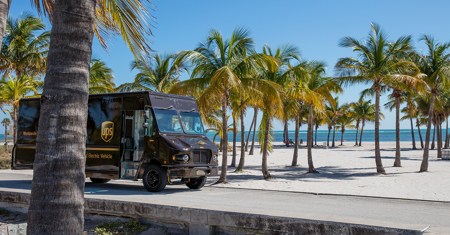 UPS electric vehicle on tropical beach road