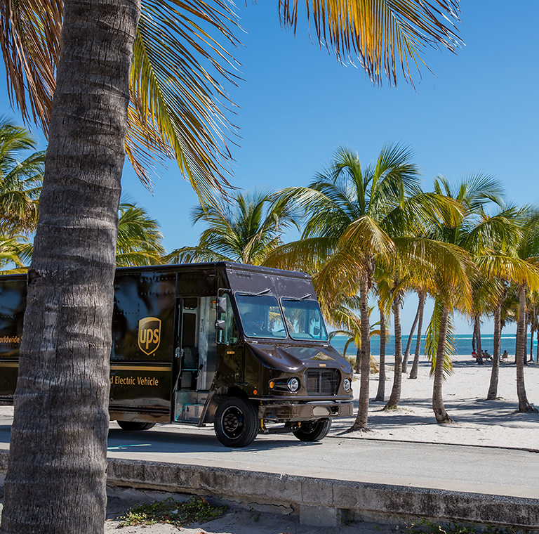 UPS electric vehicle on tropical beach road