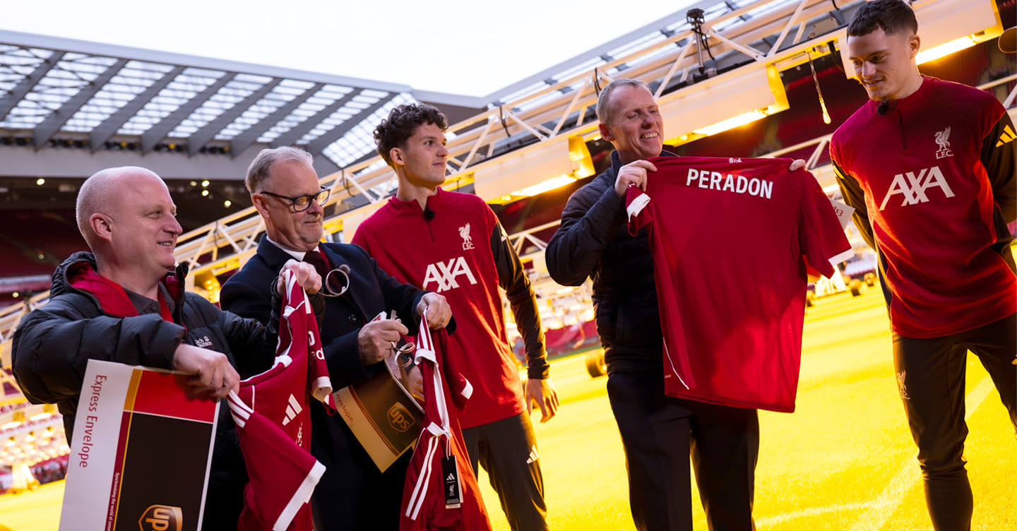 Group of men holding soccer jerseys