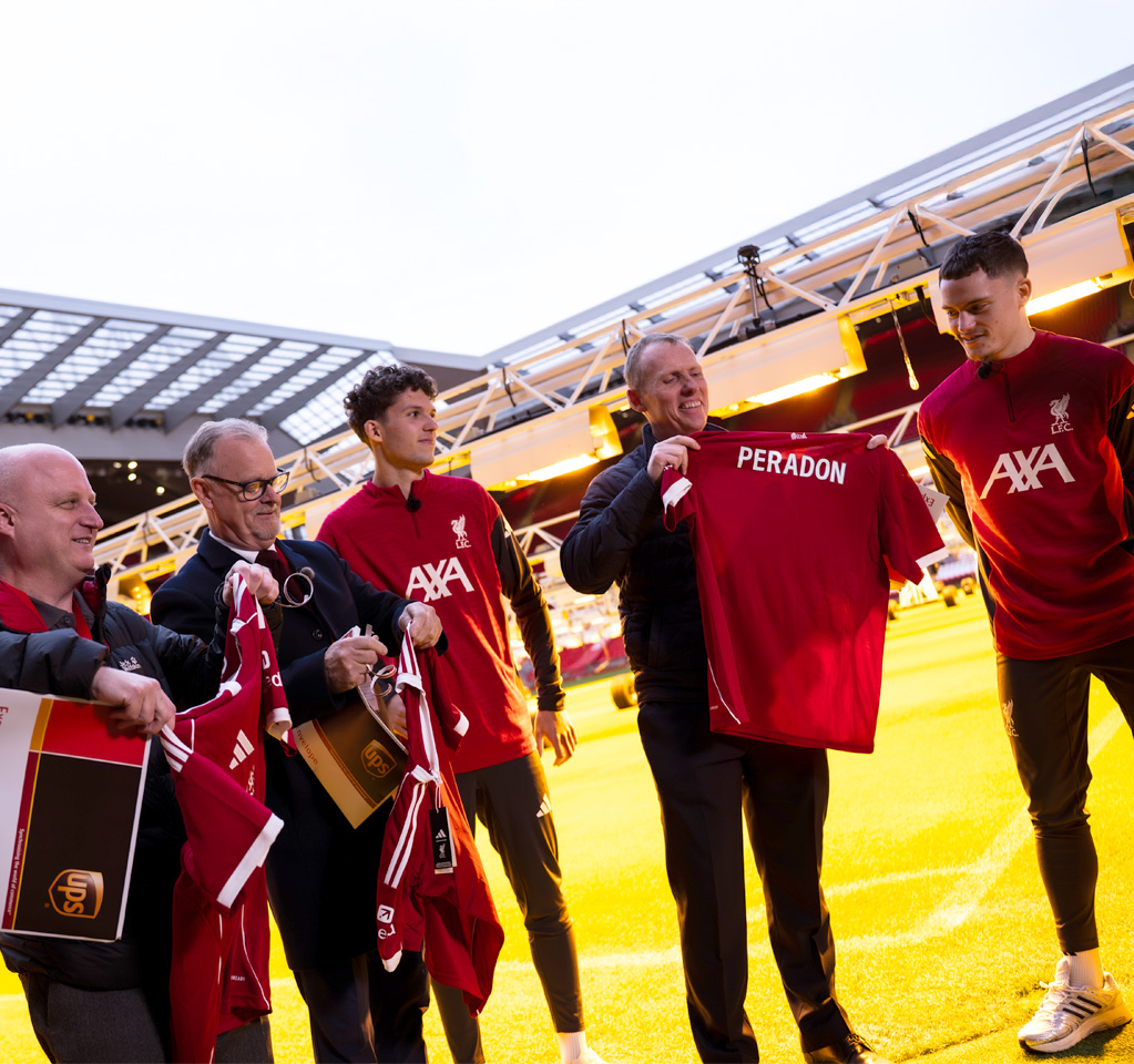 Group of men holding soccer jerseys
