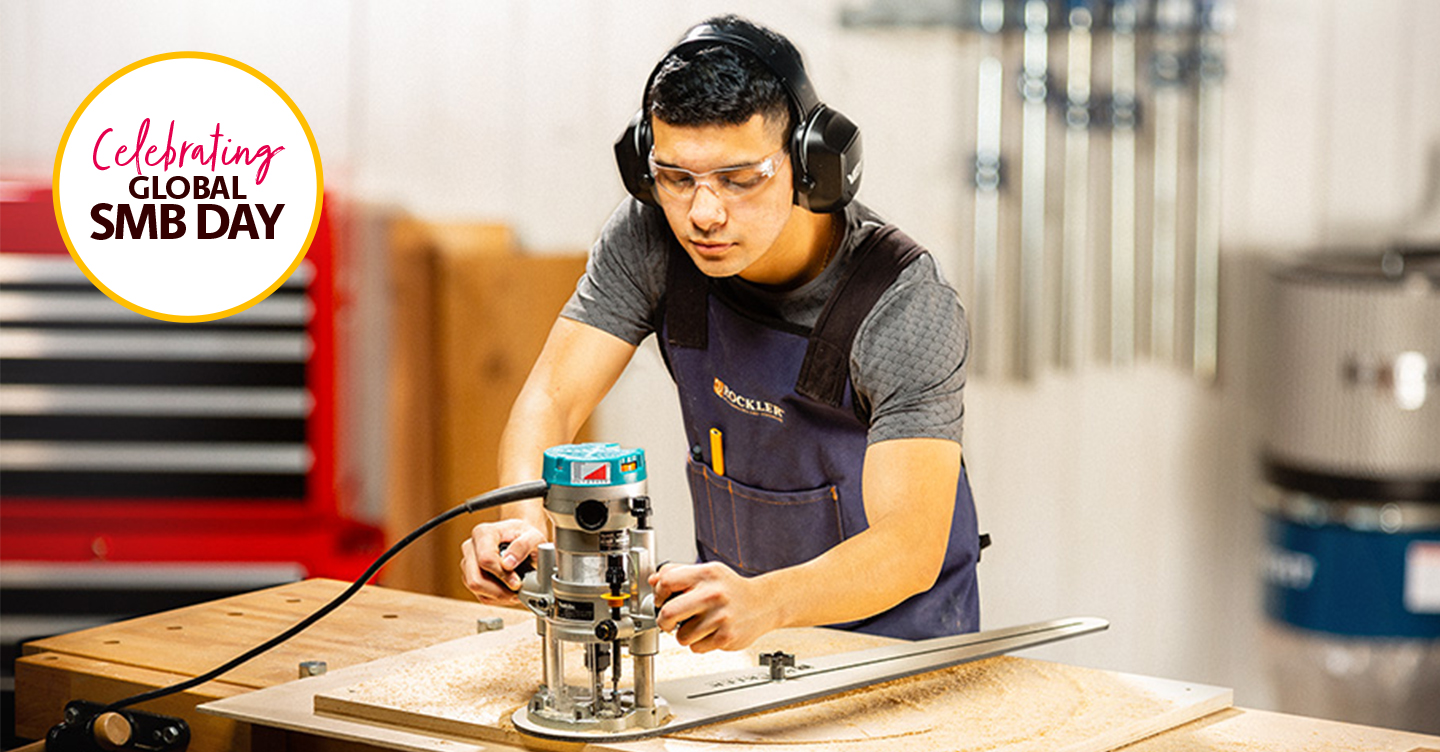 Woodworker Using Router in Workshop Setting