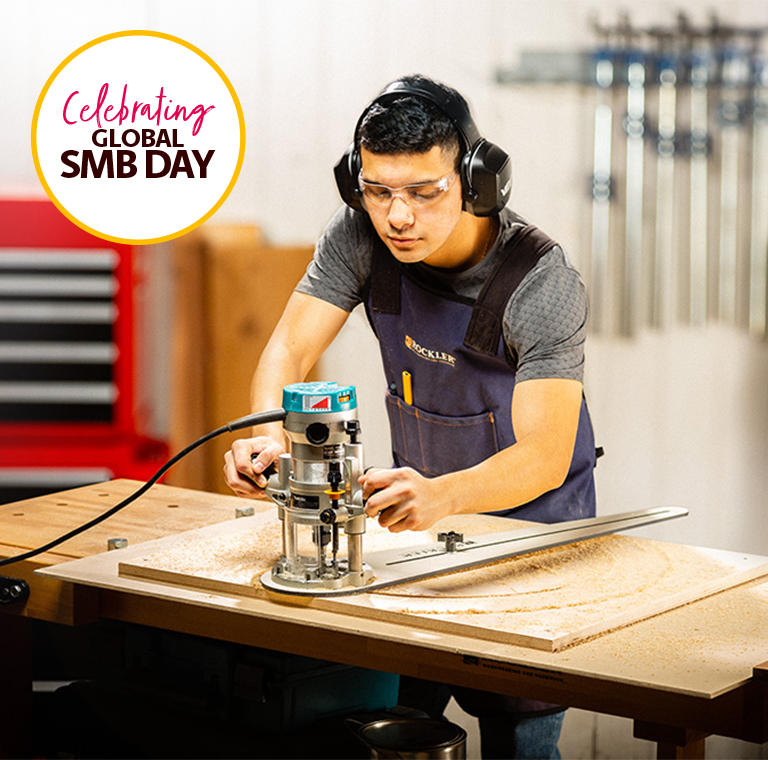 Woodworker Using Router in Workshop Setting