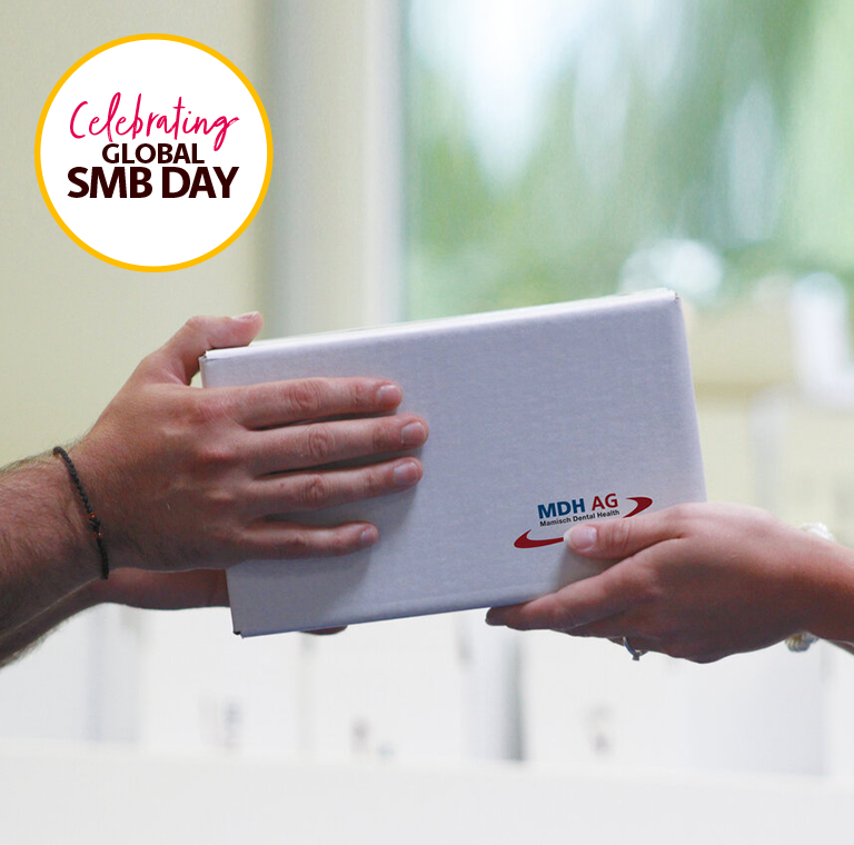 Hands Exchanging Gift Box on SMB Day