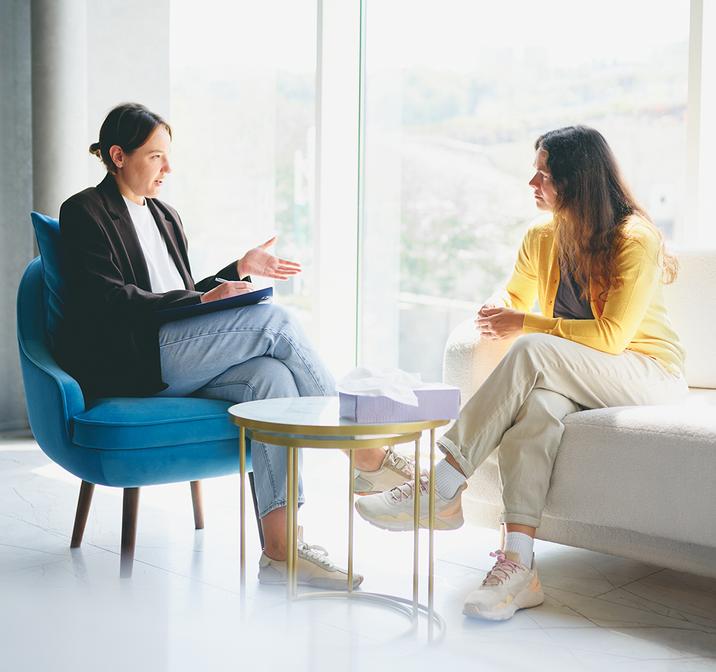 Two women talking in bright modern office