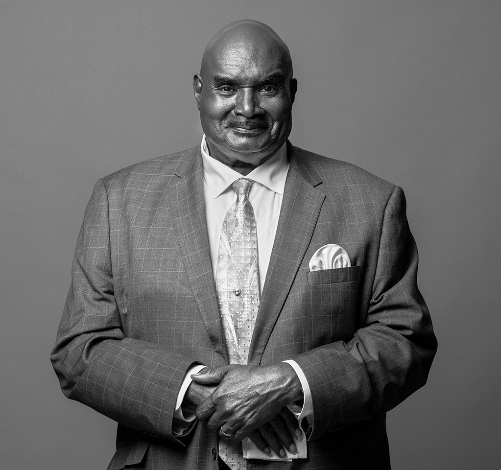 Black and white portrait of Cal Darden wearing a tailored suit and patterned tie